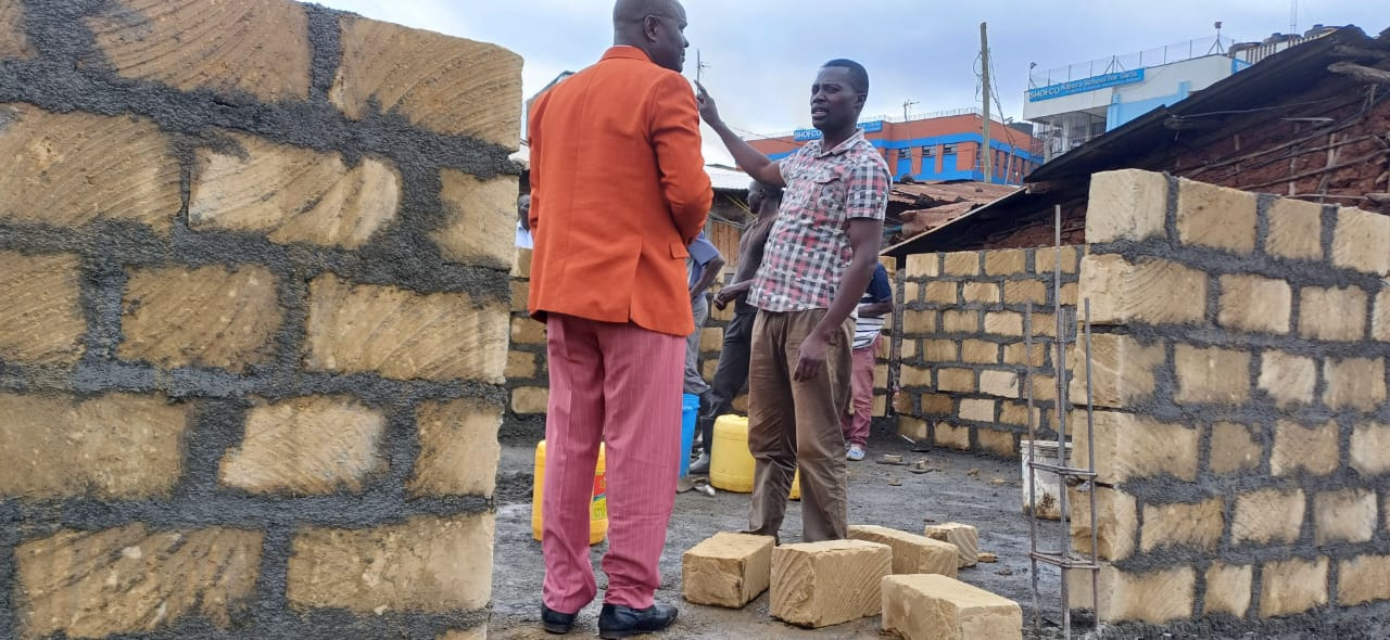 Bishop and builders at the first block walls